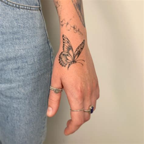 butterfly tattoo on hand|Butterfly Hand Tattoo Meaning and Symbolism: Fully。